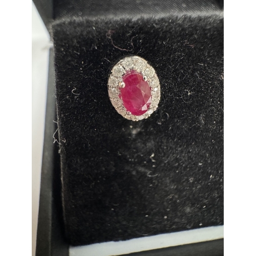 14 - A pair of 18ct ruby & diamond stud earrings