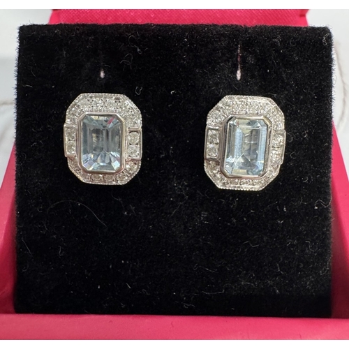 23 - A pair of 9ct white gold aquamarine & diamond stud earrings
