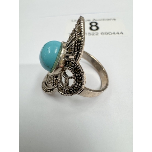 8 - A silver marcasite ring with large turquoise cabachon (6.77 grams)