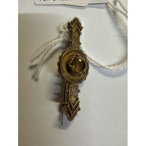 35 - A 9ct gold bar brooch with yellow stone 2.7 grams