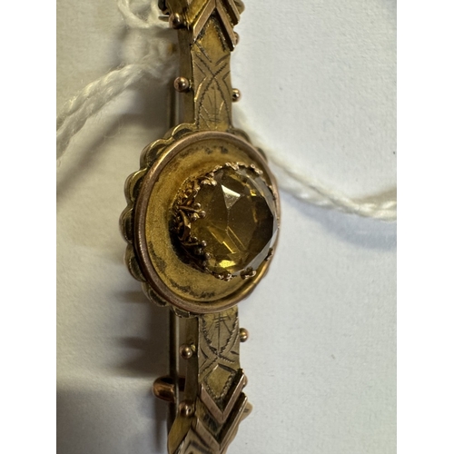 35 - A 9ct gold bar brooch with yellow stone 2.7 grams