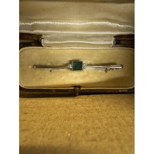 41 - An unmarked white gold brooch (tests as gold), A polished stone necklace etc