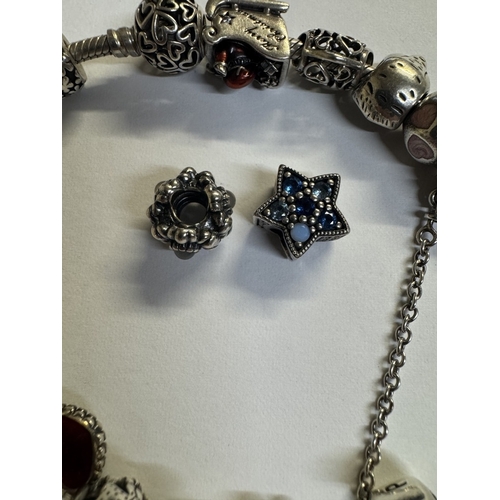 44 - A silver Pandora charm bracelet with 15 charms (Approx 70 grams)