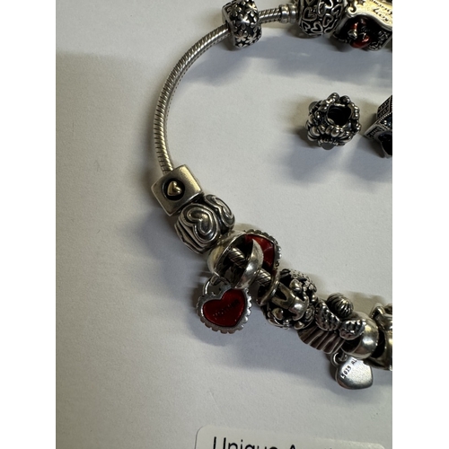 44 - A silver Pandora charm bracelet with 15 charms (Approx 70 grams)