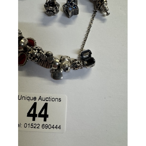 44 - A silver Pandora charm bracelet with 15 charms (Approx 70 grams)