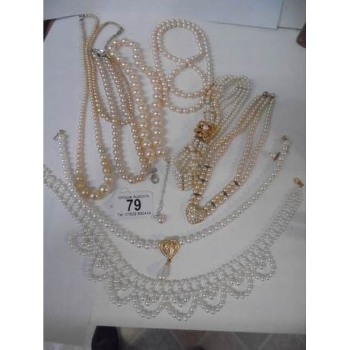 79 - Nine good faux pearl necklaces some with good fobs.