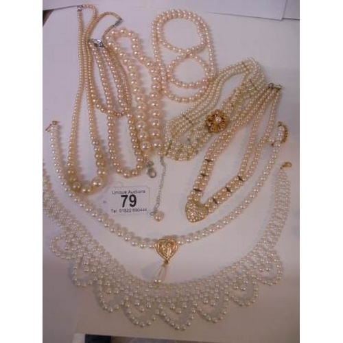 79 - Nine good faux pearl necklaces some with good fobs.