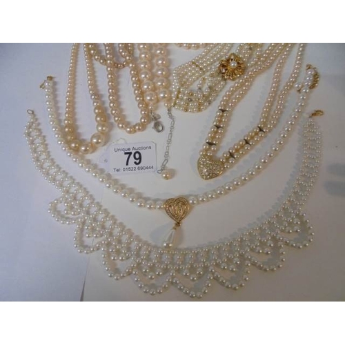 79 - Nine good faux pearl necklaces some with good fobs.