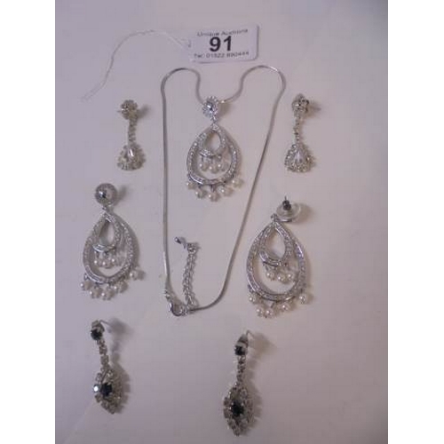 91 - A 20th century clear stone necklace with matching earrings and another two pairs of earrings.