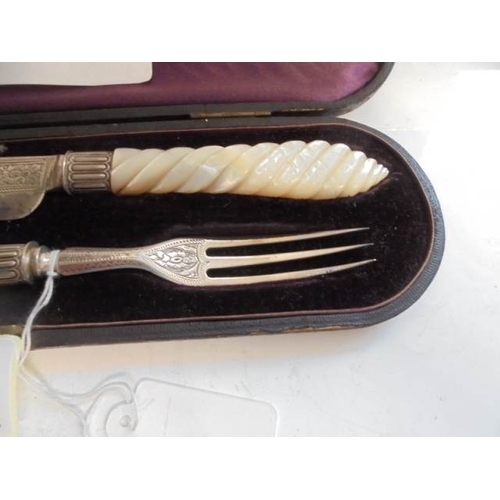 50 - A cased serving knife and fork with silver blades and mother of pearl handles, Birmingham 1872, Make... 