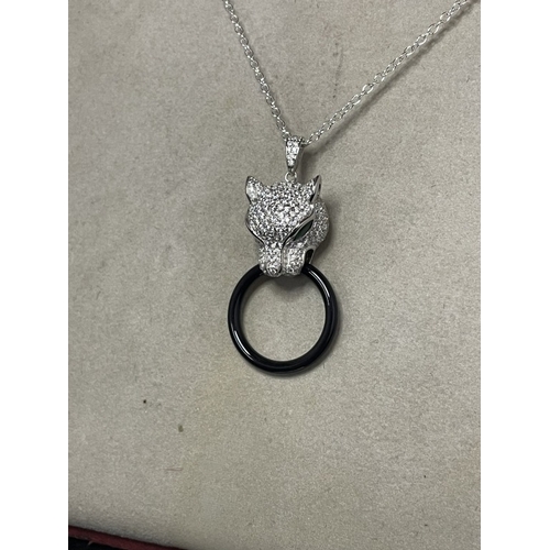 71 - A silver & cz designer style pendant necklace with emerald eyes