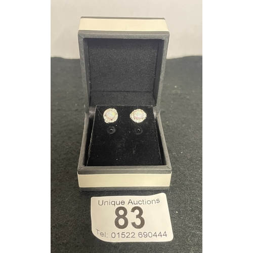 83 - A pair of silver & opal stud earrings