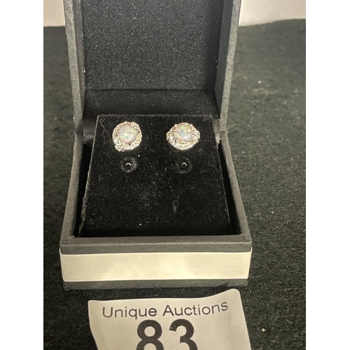 83 - A pair of silver & opal stud earrings