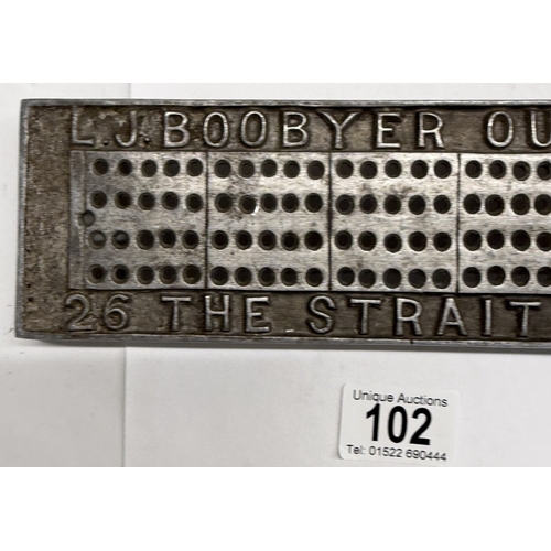 102 - An unusual metal cribbage board advertising L.J Boobyer outfitter, 26 The Strait Lincoln
