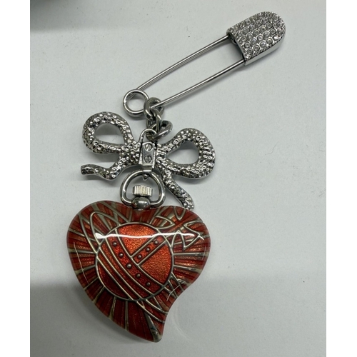 92 - A boxed Vivienne Westwood enamel heart watch brooch