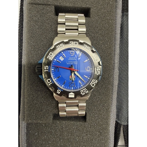 96 - A Tag Heuer Formula 1 quartz watch with blue face in case & service notes