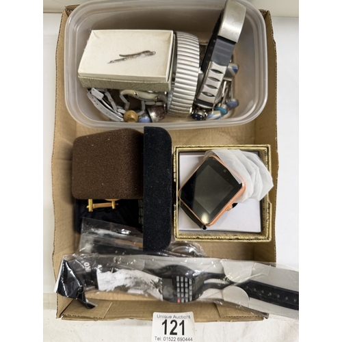 121 - A box of costume jewellery, badges, vintage watches, new watches, some silver etc