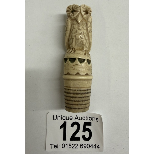 125 - A carved needlecase being an owl on thimble base