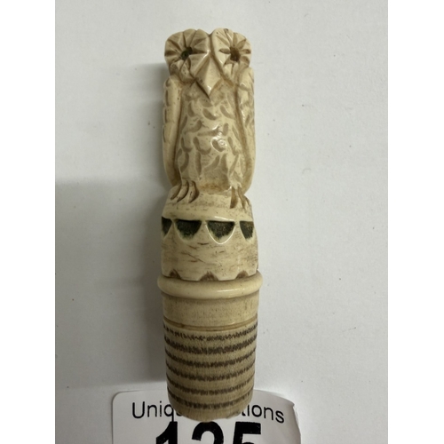 125 - A carved needlecase being an owl on thimble base