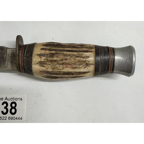 138 - A vintage hunting knife with leather sheath