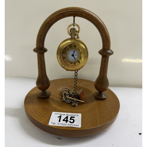 145 - An oak pocketwatch display stand with gold tone Limit 17 Jewels incabloc pocket watch & brass chain