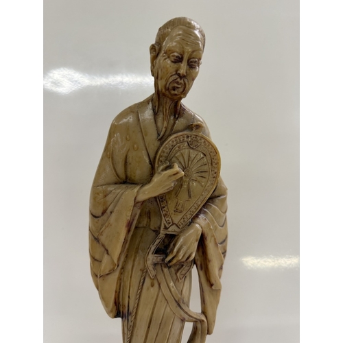 157 - A Chinese resin figurine of a scholar / gentleman