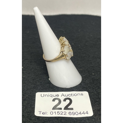 22 - A 9ct gold ring with white oval moon stones (3.42 grams)