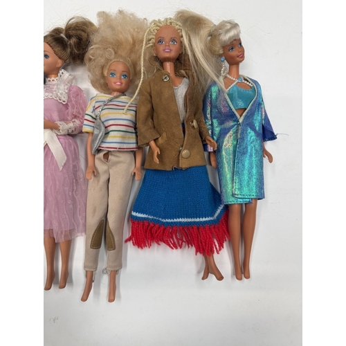 724 - 9 Barbie Dolls with clothing