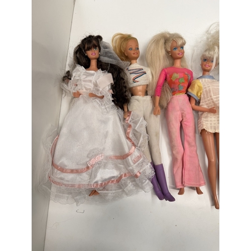 724 - 9 Barbie Dolls with clothing