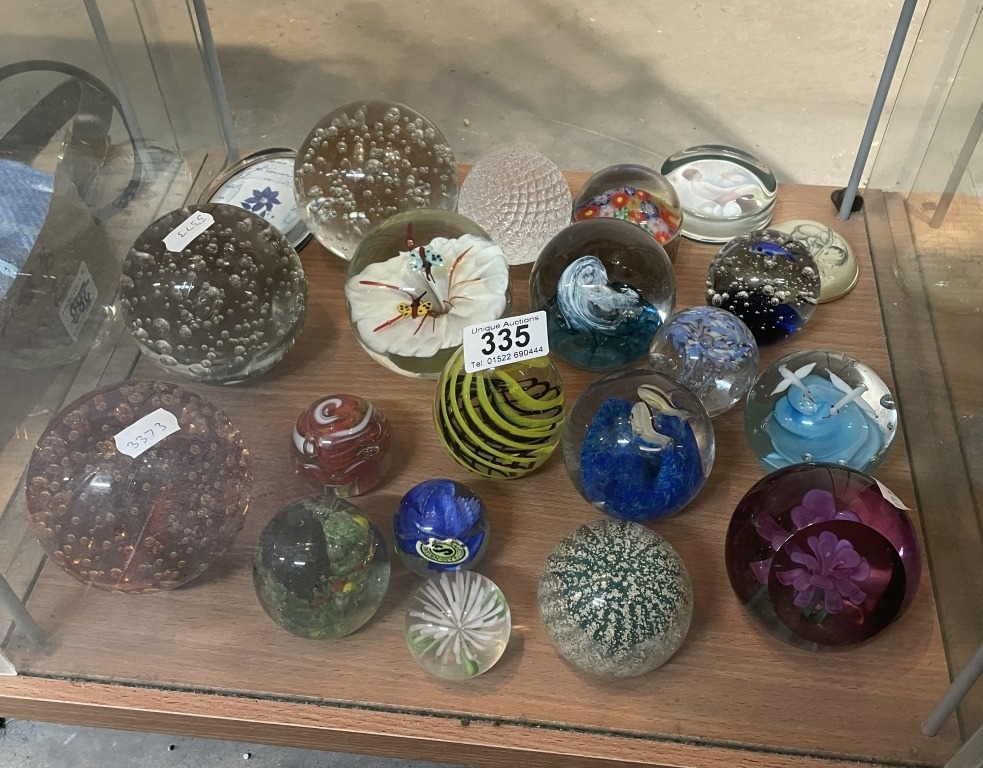 A large collection of art glass paperweights including controlled ...