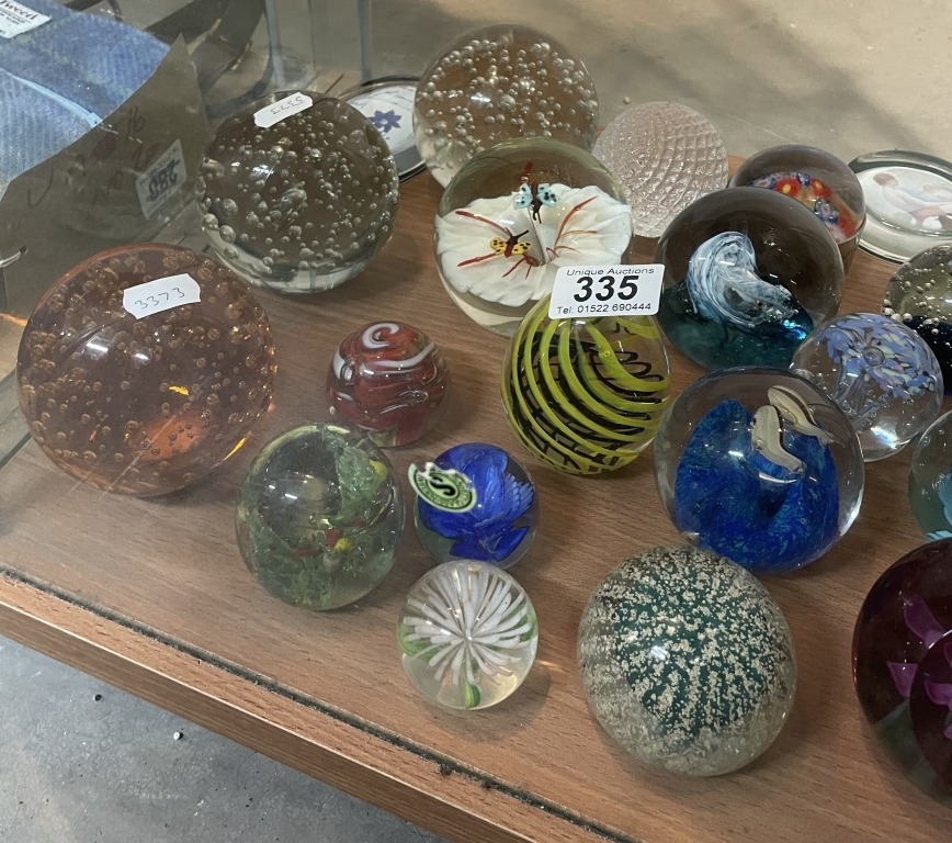 A large collection of art glass paperweights including controlled ...
