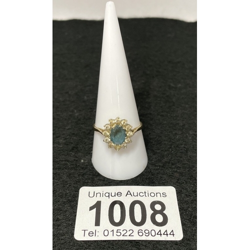 1008 - A gold ring with Topaz and cz cluster (total weight 2.62g)