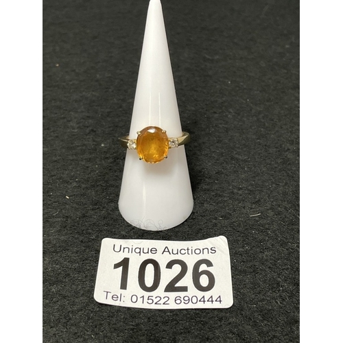 1026 - An 18ct gold citrine and diamond ring size O (total weight 5.4g)