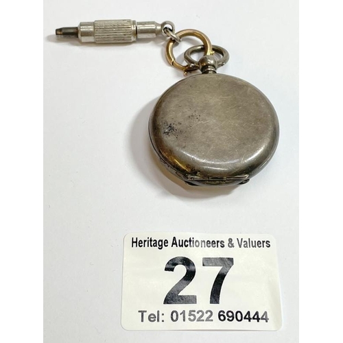 An antique silver open face pocket watch with key