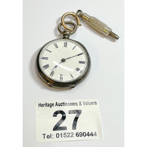 An antique silver open face pocket watch with key