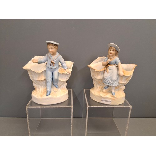 27 - A pair of Bisque porcelain boy & girl figure vases