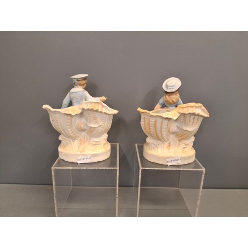 27 - A pair of Bisque porcelain boy & girl figure vases