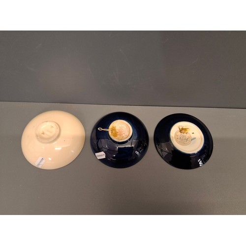 42 - Three Moorcroft Pin Dishes. Two in the hibiscus pattern and the other in the campanula pattern.