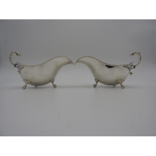 204 - PAIR VICTORIAN SILVER SAUCEBOATSSHEFFIELD, 1899 with gadrooned rims and double c-scroll handles, rai... 