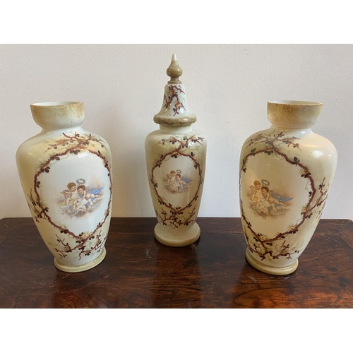 68 - A VICTORIAN GLASS 3-PIECE GARNITURE VASE SET, comprising a pair of cream coloured glass vases (33cm ... 