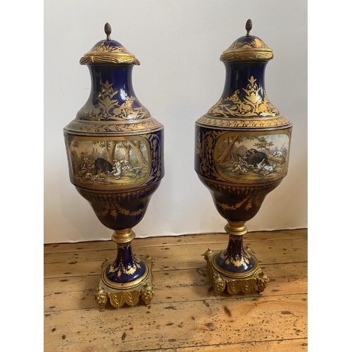 70 - IMPRESSIVE PAIR OF COBALT BLUE-GLAZED AND GILT-BRONZE MOUNTED COVERED VASES19TH CENTURYin the Sevres... 