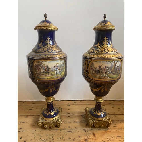 70 - IMPRESSIVE PAIR OF COBALT BLUE-GLAZED AND GILT-BRONZE MOUNTED COVERED VASES19TH CENTURYin the Sevres... 