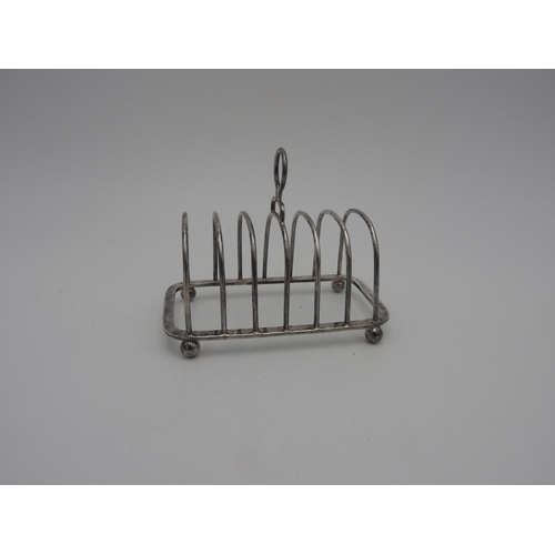 215 - SILVER TOAST RACK SHEFFIELD 1946 raised on ball feet 12cm wide 3.7 oz117 grams... 