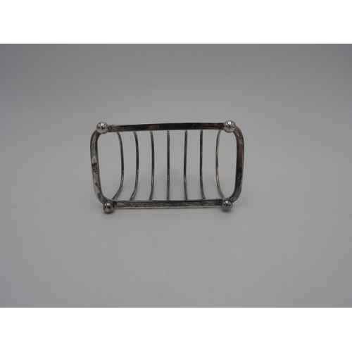 215 - SILVER TOAST RACK SHEFFIELD 1946 raised on ball feet 12cm wide 3.7 oz117 grams... 