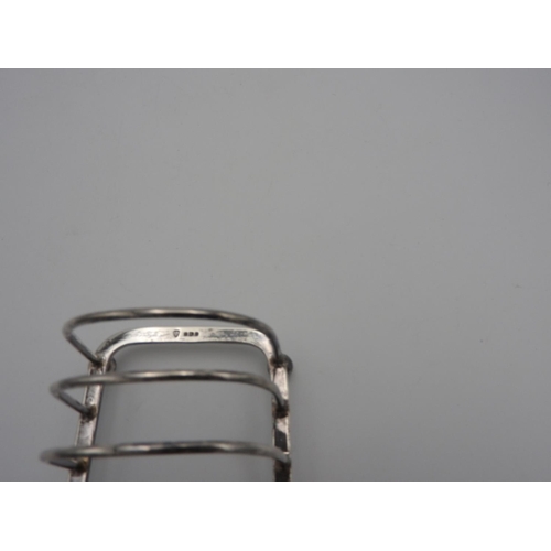 215 - SILVER TOAST RACK SHEFFIELD 1946 raised on ball feet 12cm wide 3.7 oz117 grams... 