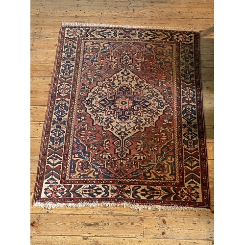 65 - BORDER PATTERN CENTRAL MEDALLION RED & FAWN WORN RUG, 201cm x 140cm