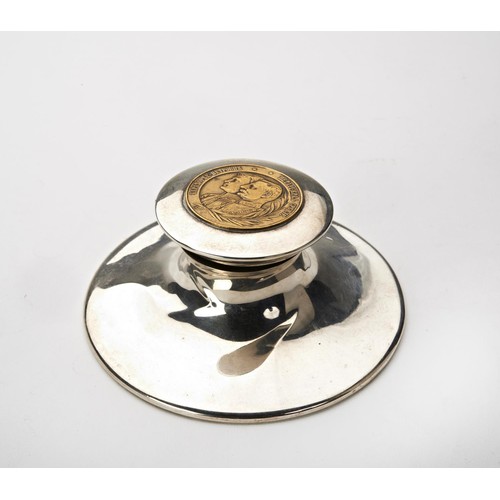 198 - COIN MOUNTED SILVER CAPSTAN INKWELL EARLY 20TH CENTURY of typical form, marks rubbed10cm diam... 