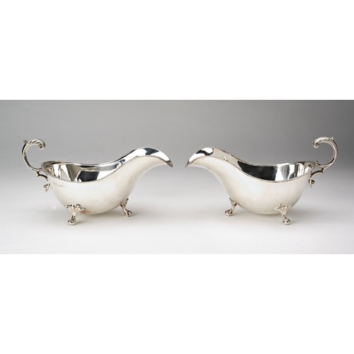 204 - PAIR VICTORIAN SILVER SAUCEBOATSSHEFFIELD, 1899 with gadrooned rims and double c-scroll handles, rai... 