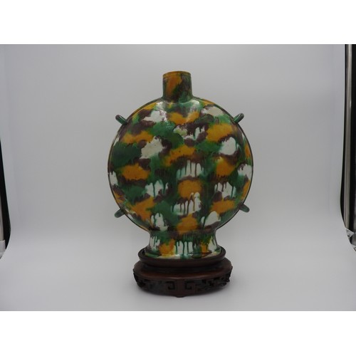 18 - SANCAI-GLAZED MOONFLASK KANGXI PERIOD the flattened ovoid sides freely splashed with yellow, aubergi... 