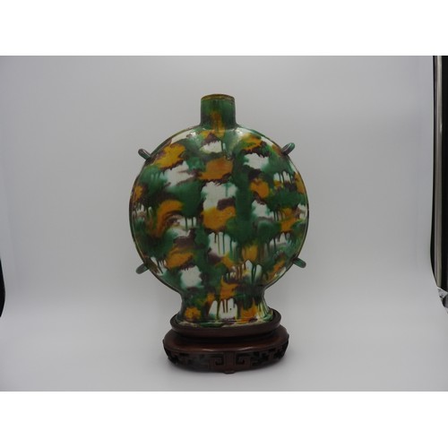 18 - SANCAI-GLAZED MOONFLASK KANGXI PERIOD the flattened ovoid sides freely splashed with yellow, aubergi... 